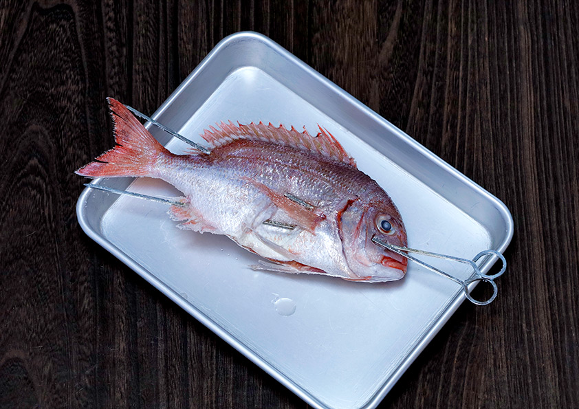 鯛は串打ち（踊り串）をして鯛の形を整えてから焼いています